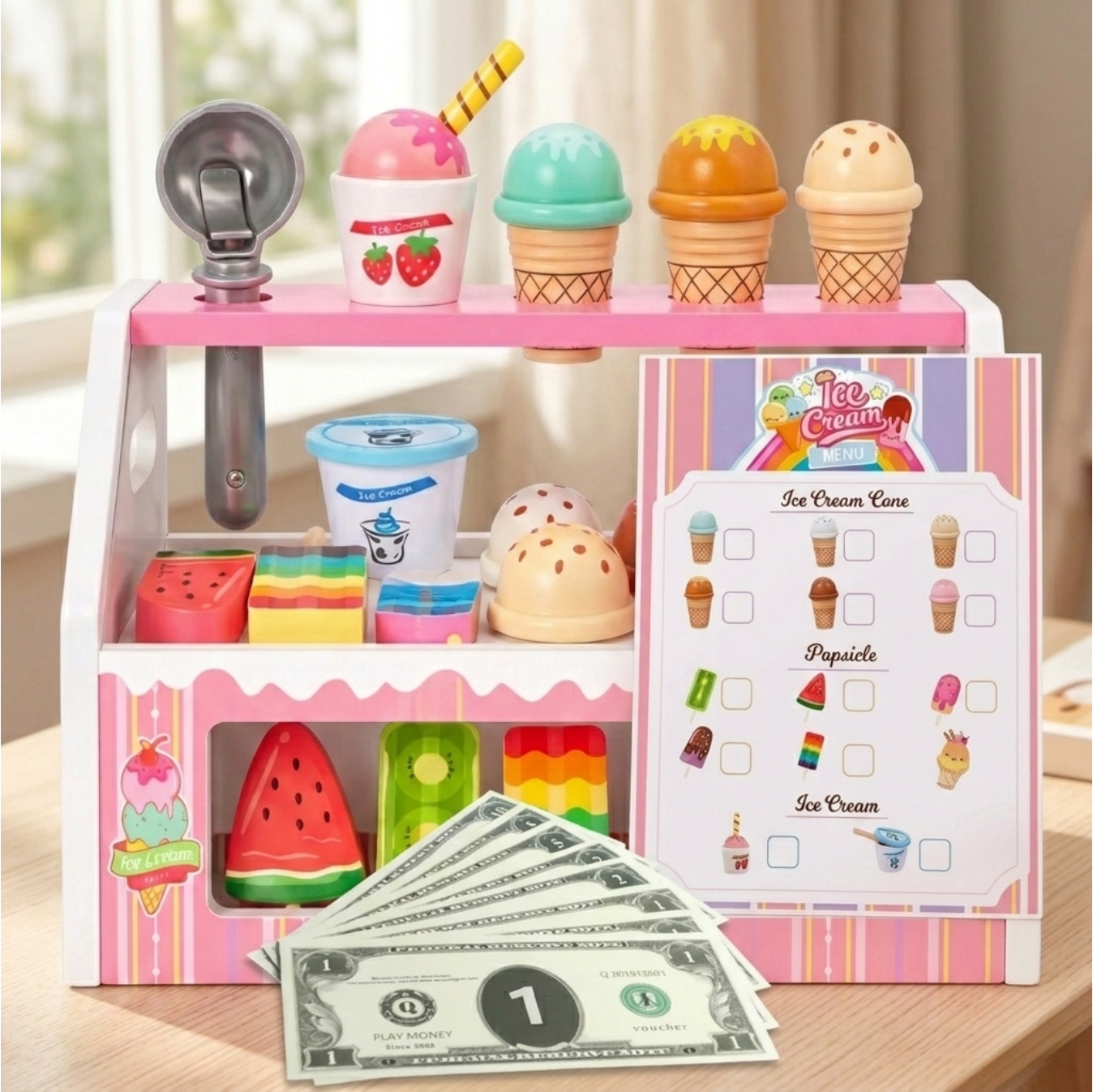 Toy ice cream shop set with ice cream cones, a scoop, and money on a wooden surface.